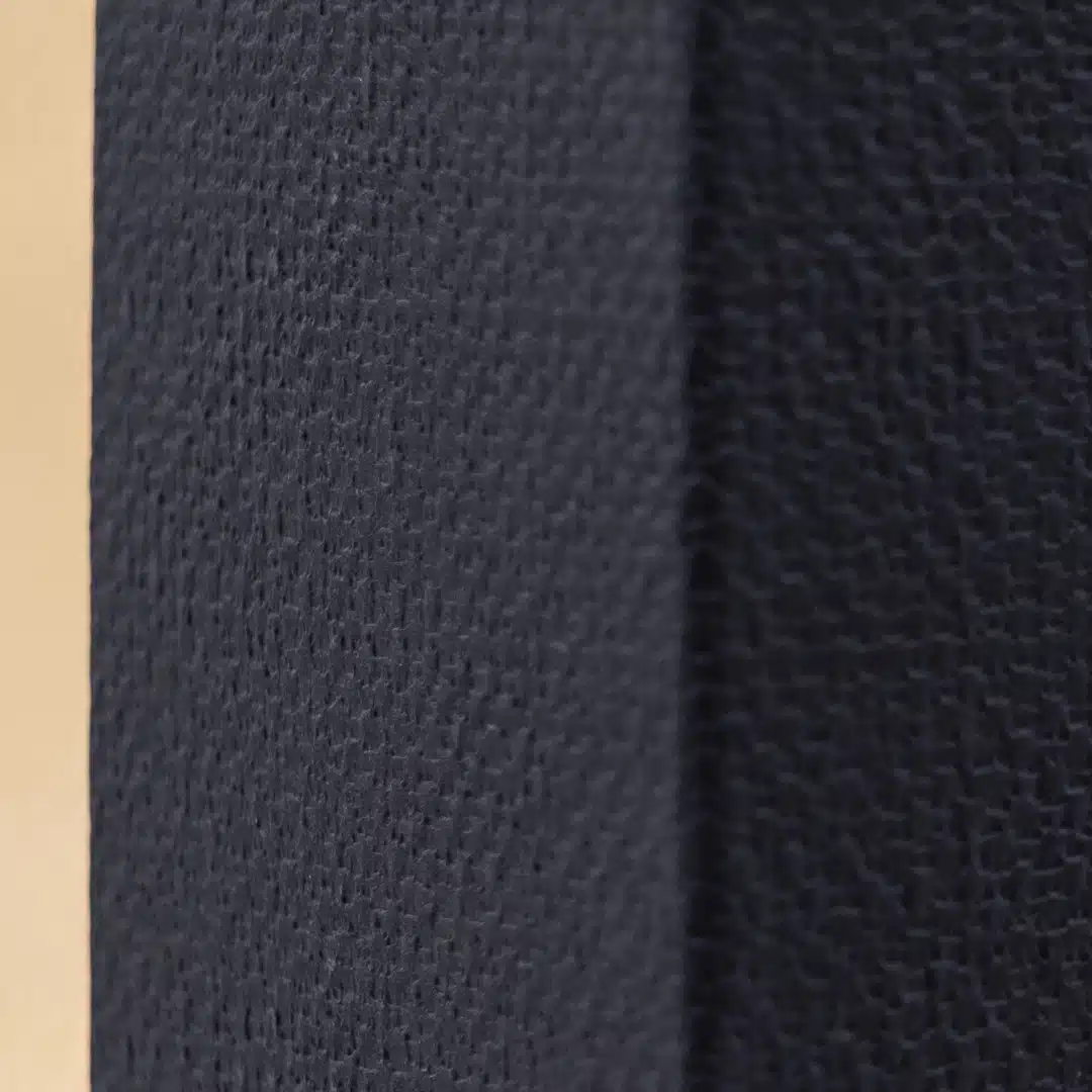 Close-up of black embossed paper texture with visible pattern