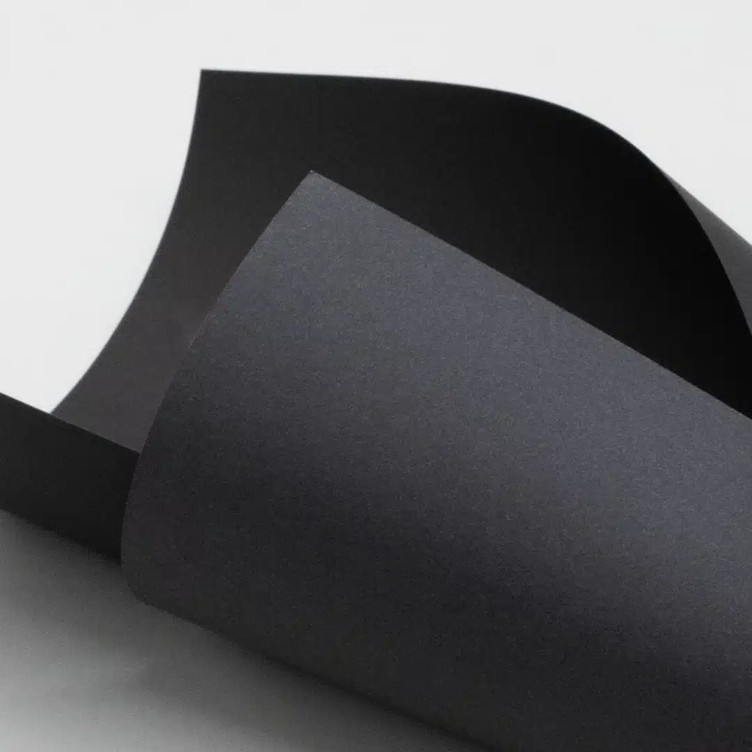 Folded black paper sheets with rich texture and deep color